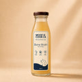 Bottle of Woof & Cook Bone Broth on a beige background